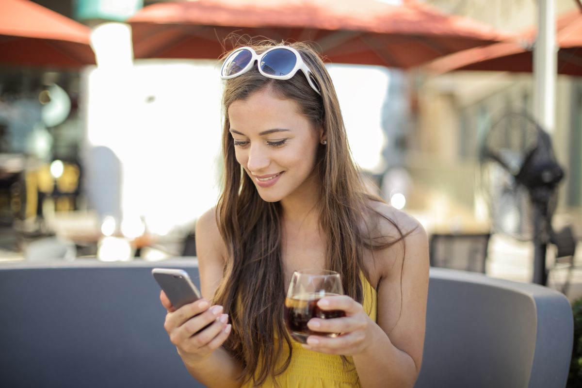 Young woman using several social media apps on her phone.
