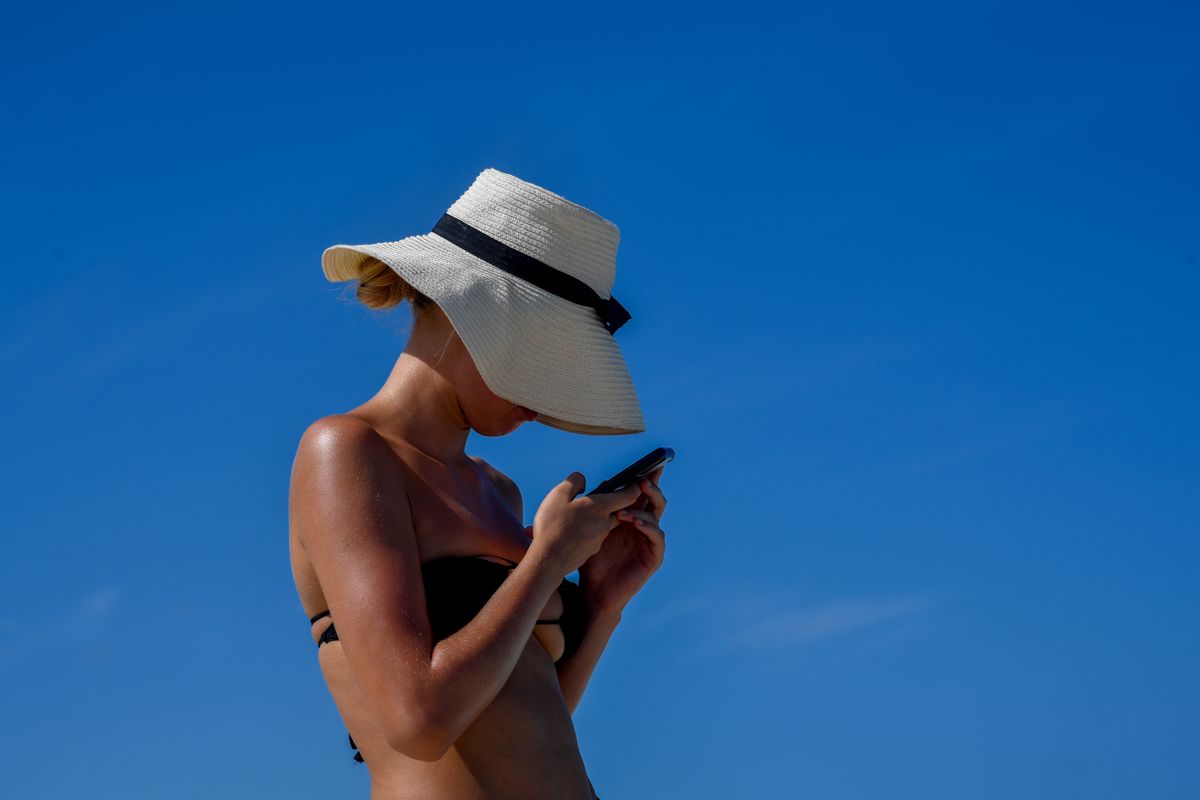 Young woman creating social media content on her phone.