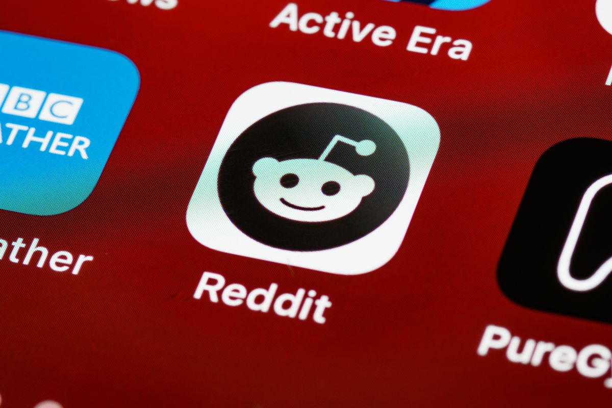 A creator browsing Reddit communities on a phone at home