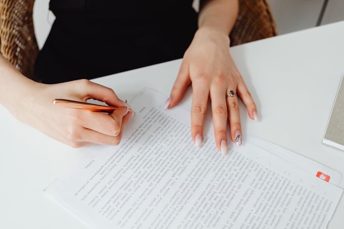 A creator reviewing an agency agreement on a laptop at a bright desk